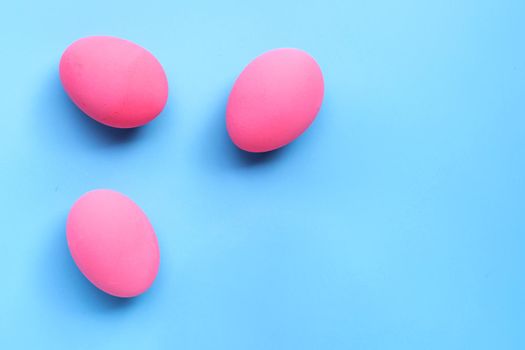 Easter Eggs, Pink eggs on blue background. Copy space