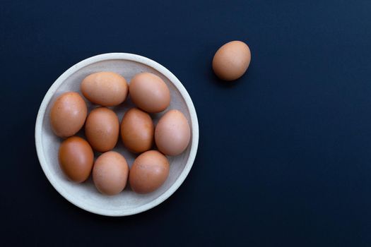 Eggs on dark background. Copy space