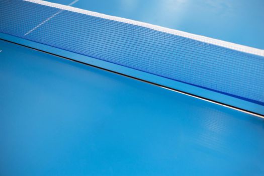 Net of table tennis ping pong on blue background.