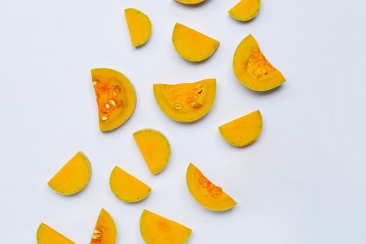 Cut and slices butternut squash on white background.