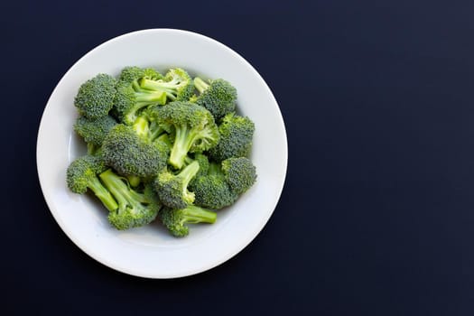 Fresh green broccoli on dark background.