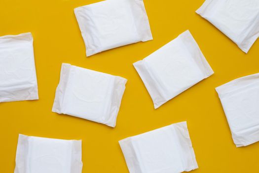 White sanitary pads on yellow background.