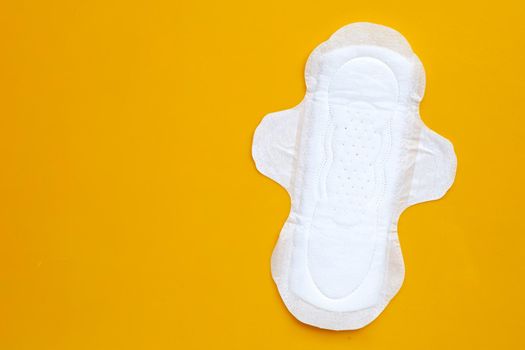 White sanitary napkin on yellow background. Copy space