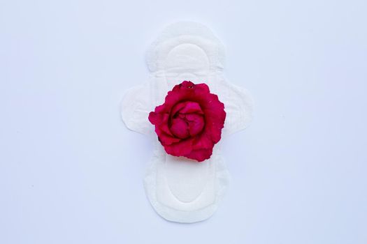 White sanitary napkin with red rose on white.