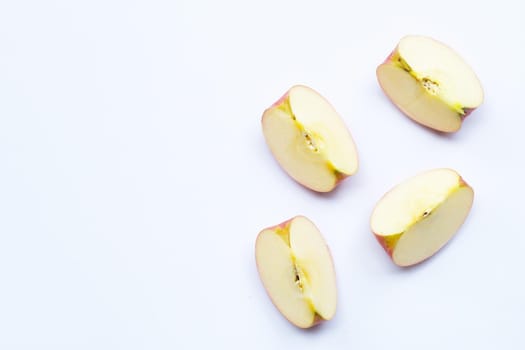 Ripe apple slices on white background.