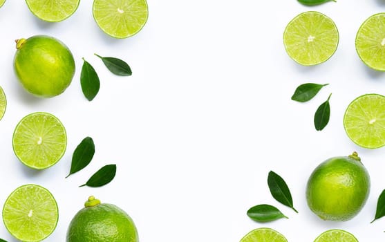 Frame made of fresh limes with leaves isolated on white background.