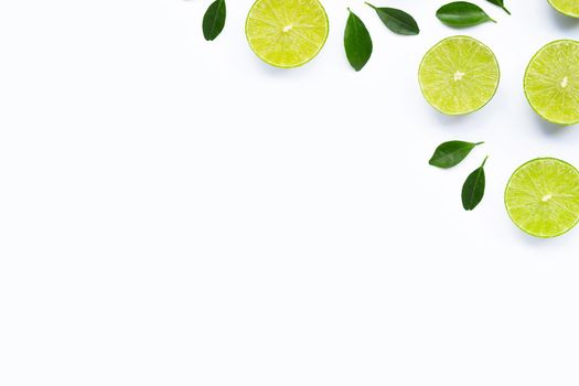 Limes with leaves isolated on white background.