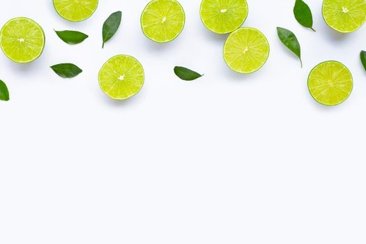 Limes with leaves isolated on white background.