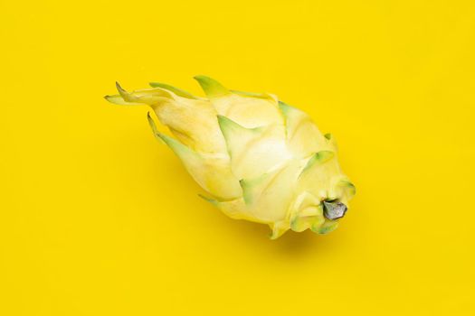 Yellow pitahaya or dragon fruit on yellow background. Copy space