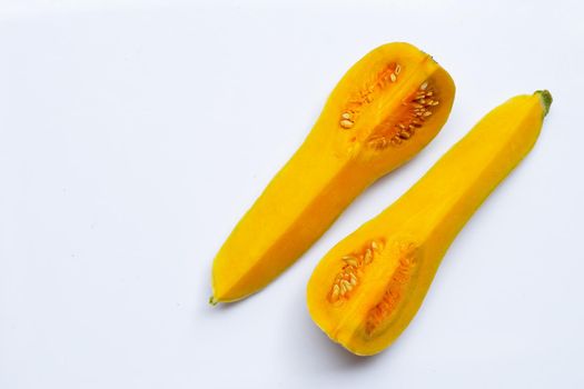 Cut and slices butternut squash on white background.