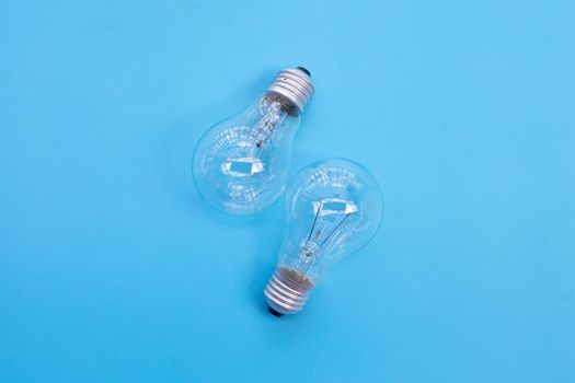 Light bulbs on blue background. Ideas and creative thinking concept. Top view