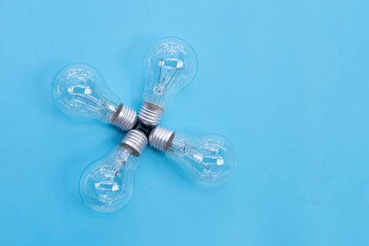 Light bulbs on blue background. Ideas and creative thinking concept. Top view