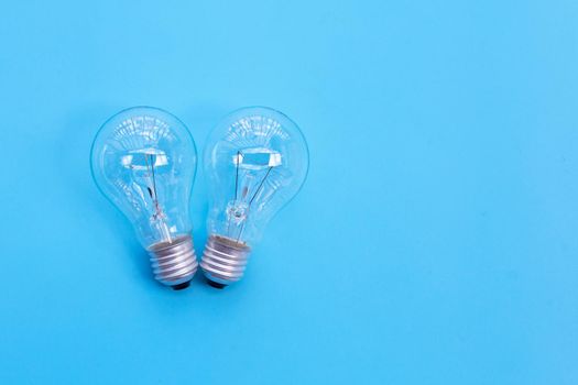 Light bulbs on blue background. Ideas and creative thinking concept. Top view