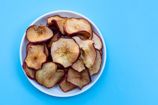 Dried apple slices on blue background