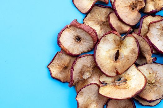 Dried apple slices on blue background