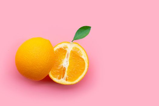 High vitamin C, Juicy and sweet. Fresh orange fruit on pink background.