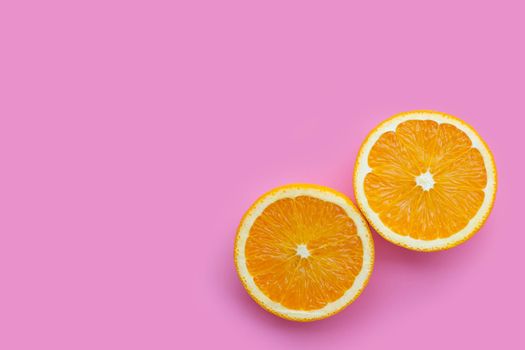 High vitamin C, Juicy and sweet. Fresh orange fruit on pink background.