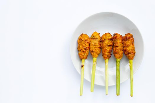 Grilled minced chicken with curry paste and coconut cream on lemongrass skewers. Top view