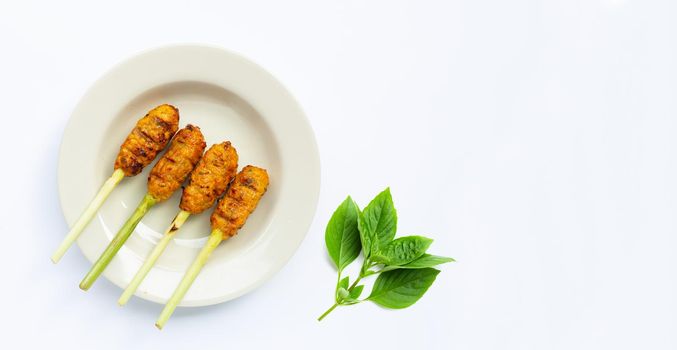 Grilled minced chicken with curry paste and coconut cream on lemongrass skewers. Top view