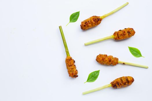 Grilled minced chicken with curry paste and coconut cream on lemongrass skewers. Top view