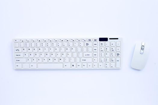 White computer keyboard and mouse on white background. Copy space