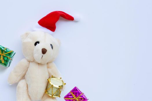 Toy bear wearing a santa hat on white background. Christmas holidays concept