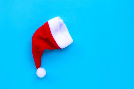 A santa hat on blue background. Copy space