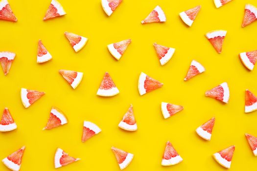 High vitamin C. Juicy grapefruit slices on yellow background.