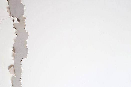 White color paint peeling off on ceiling house. Under the roof