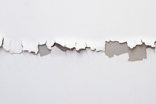 White color paint peeling off on ceiling house. Under the roof