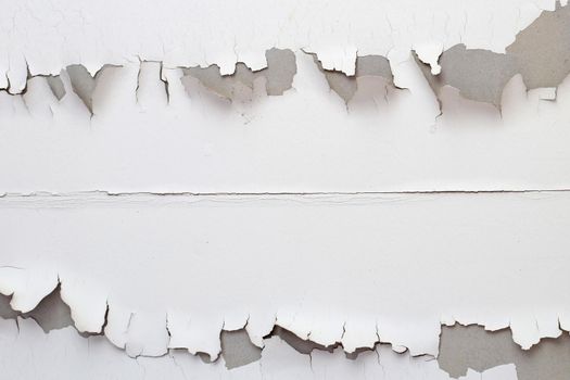 White color paint peeling off on ceiling house. Under the roof