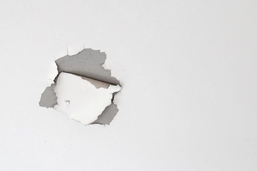 White color paint peeling off on ceiling house. Under the roof