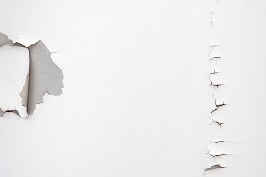 White color paint peeling off on ceiling house. Under the roof
