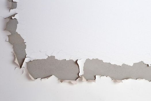 White color paint peeling off on ceiling house. Under the roof