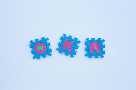 OKR alphabet puzzles on white background.