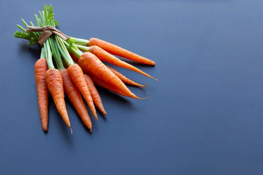 Fresh carrots on dark background.