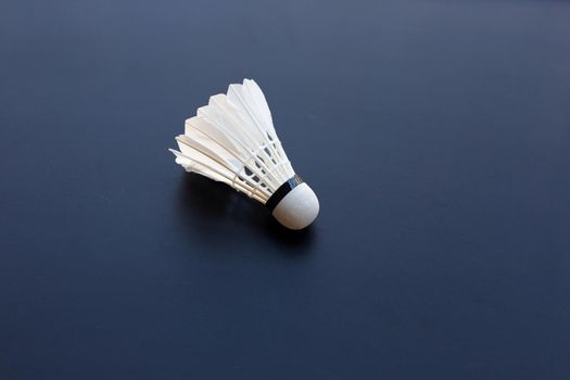Shuttlecock or badminton ball on dark background.