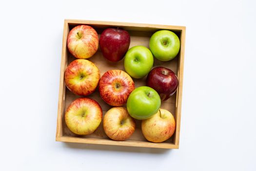 Fresh apples in wooden box on white background.