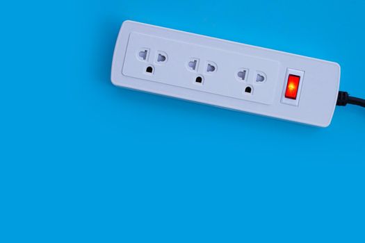 Electrical power strip on blue background. Top view