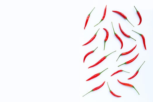 Hot chili peppers on white background. Top view