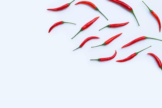 Hot chili peppers on white background. Top view