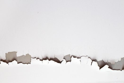 White color paint peeling off on ceiling house. Under the roof