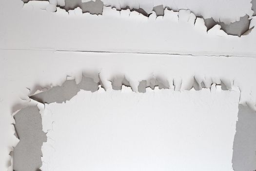 White color paint peeling off on ceiling house. Under the roof