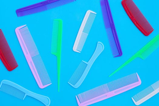 Combs on blue background. Top view