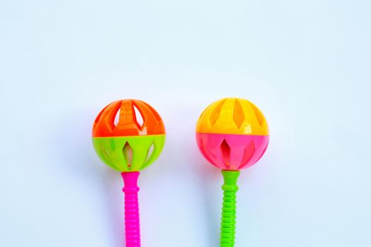 Colorful baby rattles on white background. Copy space