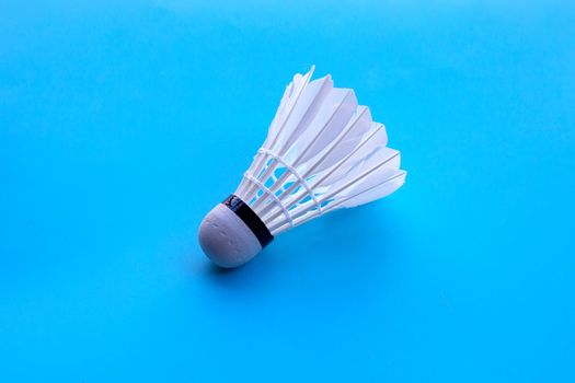 Shuttlecock or badminton ball on blue background.
