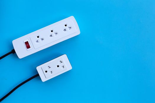 Two electrical power strip on blue background. Top view