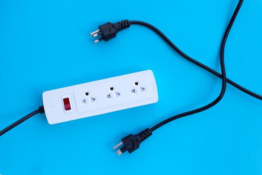 Electrical power strip and plugs on blue background. Top view