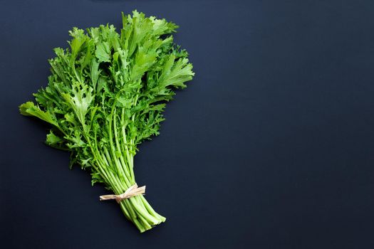 Mustard Green on dark background.