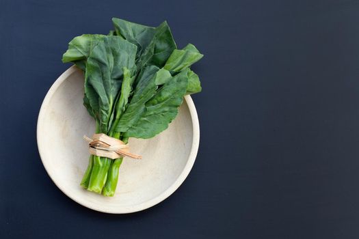 Collard green on dark background. 